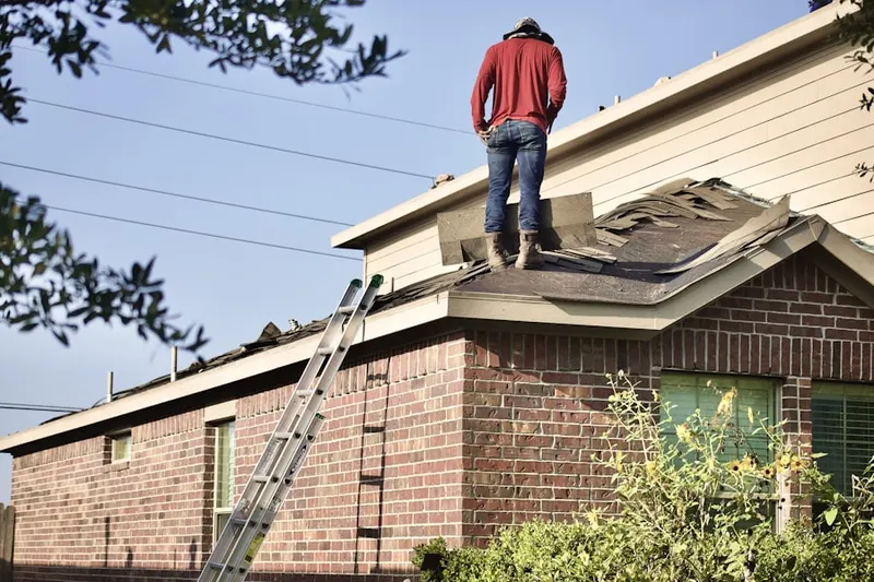 Professional roofer working on a residential roof in Wooded Pond